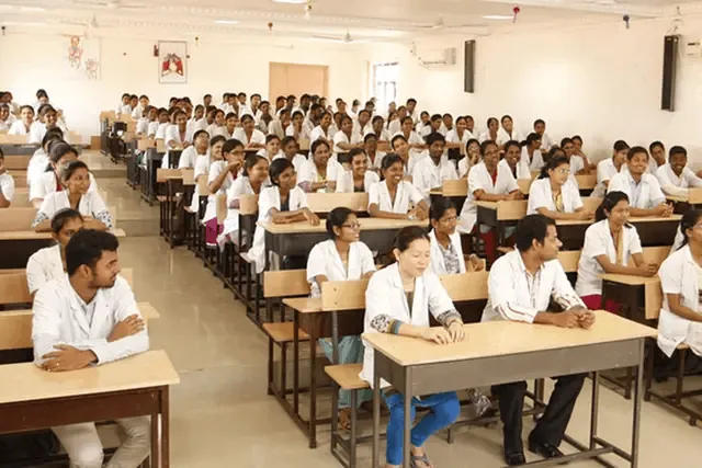 Students in white coats seated for a lecture at AVMCH