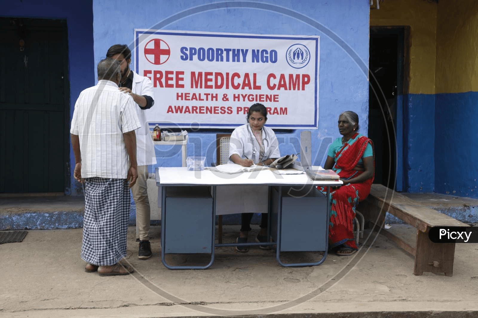 Doctor consulting residents at a free medical camp and hygiene awareness programme